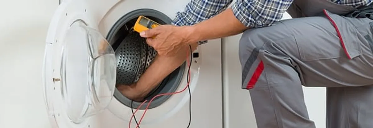 Dryer repair technician inspecting and repairing a clothes dryer in Glendale, AZ